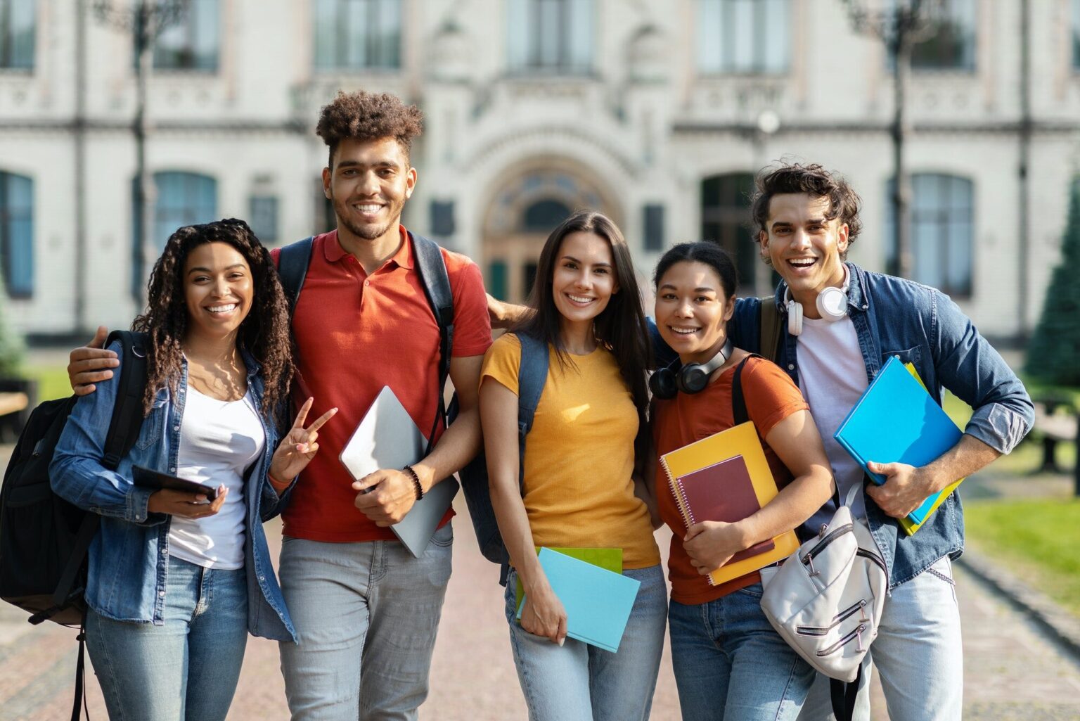 group-of-happy-international-students-posing-outdoors-near-university-building-1536x1025